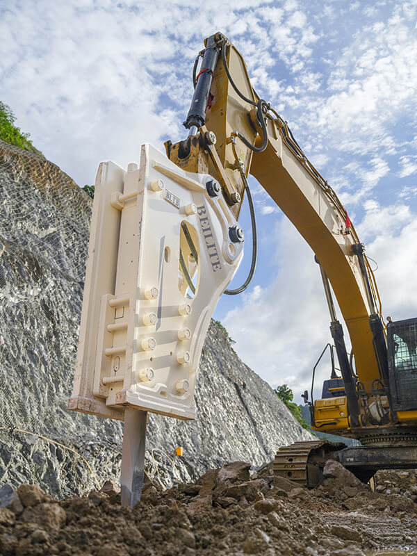 a-white-side-mount-hydraulic-breaker-is-breaking-up-the-ground