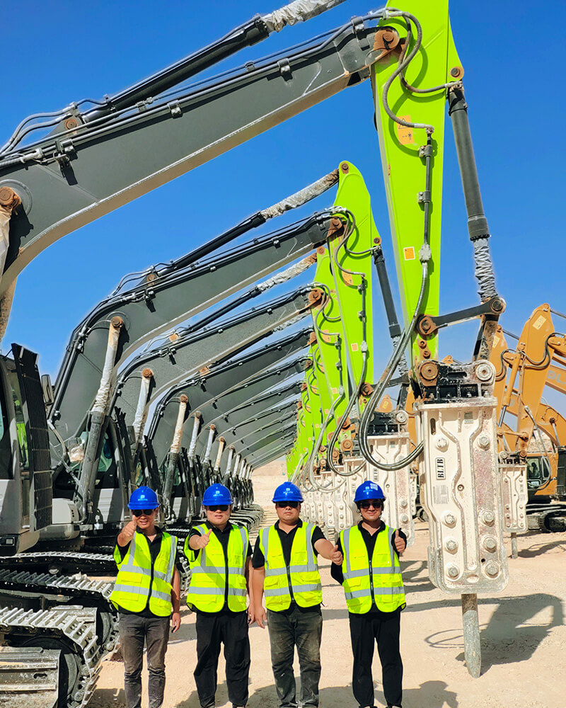 service-technician-stands-in-front-of-an-excavator-equipped-with-our-product